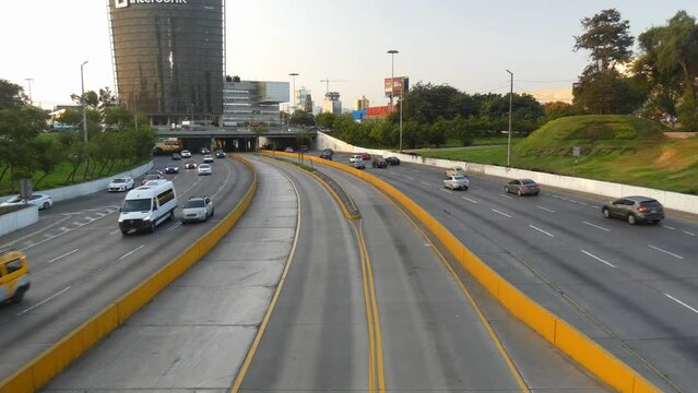 4k video of a freeway called "V&iacute;a Expresa Luis Fern&aacute;n Bedoya Reyes" with lanes at both sides and in the middle is lane for the bus rapid transit system called "Metropolitano" Located in Lima, Peru.