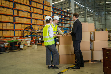 Warehouse managers and worker working together in warehouse office in a large distribution warehouse,Logistic industry concept.