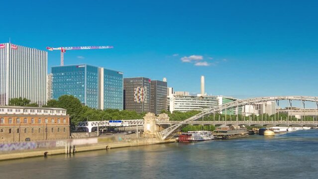 The Austerlitz viaduct in Paris paanoramic timelapse hyperlapse, seen from bridge over the river Seine with a metro train passing, is a single-deck, steel arch, rail bridge that was built in 1904