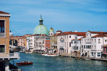 Fototapeta na wymiar Venice Grand canal and Basilica di Santa Maria della Salute with old architecture, Italy in springtime or summer.