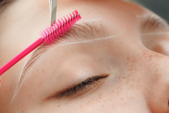 Brow correction, Master tweezers depilation of eyebrow hair in women