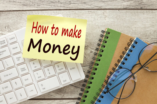 How to make money. top view of notepad with text. white keyboard. glasses on a notebook