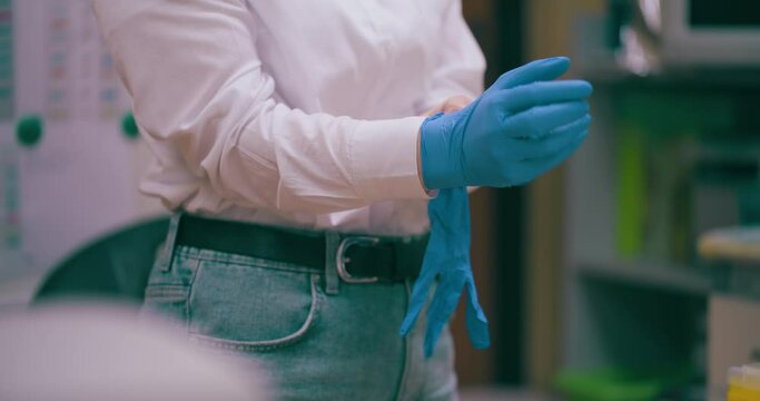 Scientist At Laboratory Wearing Protective Gloves