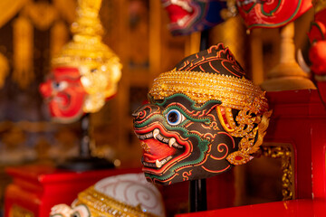 Close up of beautiful ancient traditional Thai pattern Pantomime or Khon masks are set up on wooden...