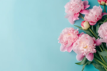 Fototapeta na wymiar Bouquet of blossom peonies on blue background, 8 march, woman's day, mother's day concept banner with empty space for text