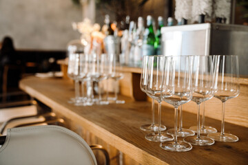 Empty wine glasses on bar at cafe