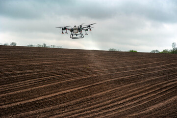 spraying fields with drones, plowing agricultural fields, applying fertilizers with drones