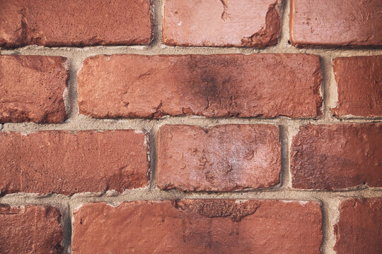 Abstract weathered texture stained with aged paint, rough rusty masonry blocks. Close-up of a brick wall. Overlay for your design with the ability to copy. High quality photo