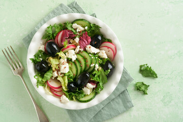 Lettuce salad, cucumber, radish salad with cottage cheese and flax seeds olive oil salad. Healthy diet food. Diet menu and balanced diet. Top view.
