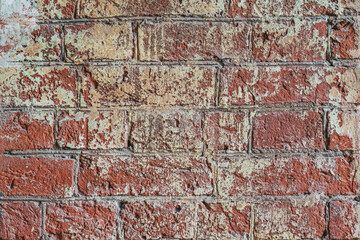 Dirty shabby painted brick surface, paints of different colors. Colorful grunge texture of wall