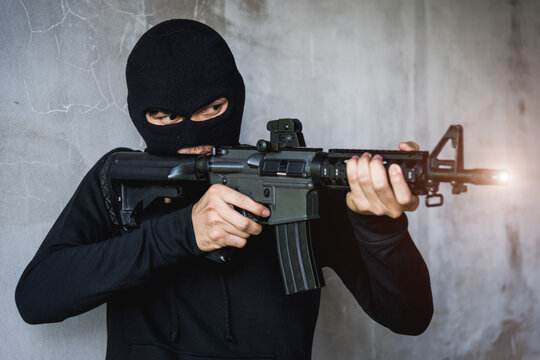 Commando with Helmet holding M16 gun points already shoot
