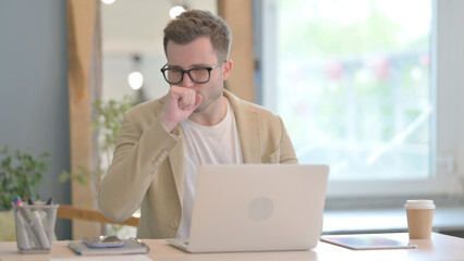 Young Businessman having Coughing Working on Laptop