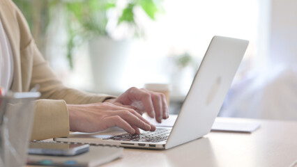 Side View of Businessman Working on Laptop