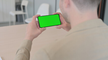 Man Holding Phone with Chroma Key Screen