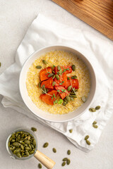 Portion of healthy breakfast millet porridge with baked pumpkin
