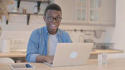 Fototapeta premium Shocked Young African Man Working on Laptop