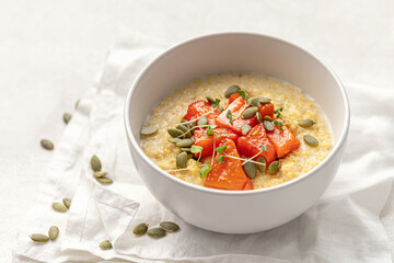 Portion of healthy breakfast millet porridge with baked pumpkin