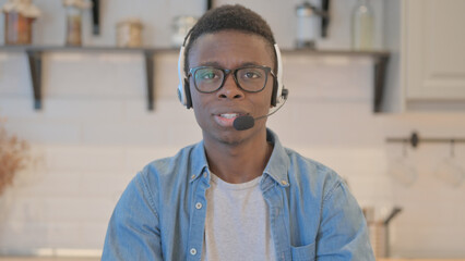 Young Businessman with Headset Talking with Customer