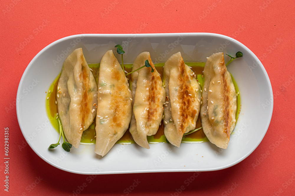 Wall mural Portion of japanese gyoza dumplings on pink background - Wall murals