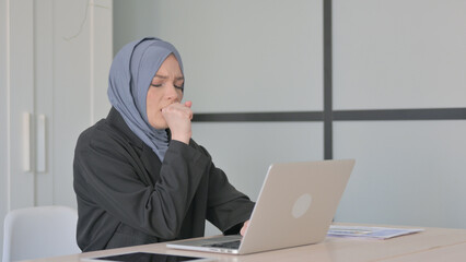 Muslim Businesswoman having Coughing Working on Laptop