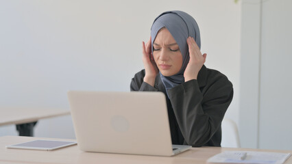 Arab Businesswoman with Headache Working on Laptop