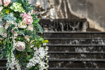 Flowers wedding floral decoration against the backdrop of a fountain, copy space.