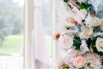 Delicate light pink European bouquet in a bright room with a white curtain. High quality photo