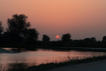 beautiful and serene sunset at the al qudra lake