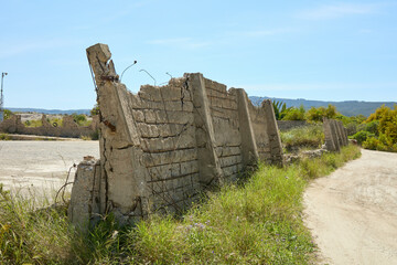 fence on the beach in reinforced concrete worn by the weather