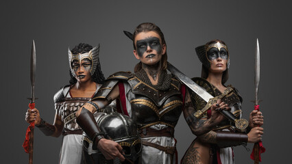 Studio shot of ancient female warriors armed with cold steel posing together.