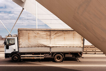 Transportation and logistics, old truck crossing the bridge - obrazy, fototapety, plakaty