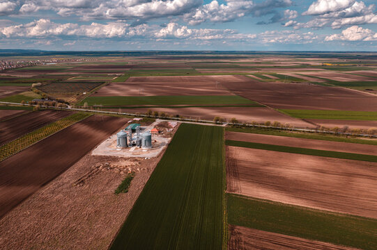 Aerial shot of grain silos in countryside landscape, drone pov