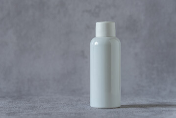 Bottle for medicine or cosmetics on a grey background.