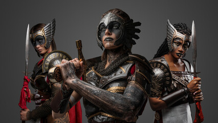 Shot of isolated on grey background female warriors from past with spears and sword.