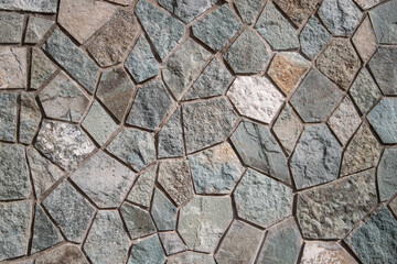 Outdoor wall neatly trimmed with flagstone background.