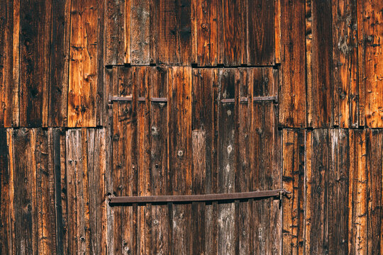 Old farm barn doorway, worn wooden surface as background