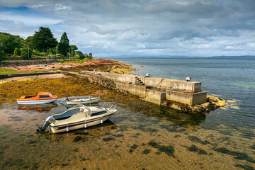 Boats moored at Sandstone Quay (also called Sheep Harbour), well known for its sheep cleats, at...