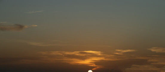 Sunset sunrise over Patong Beach Phuket Thailand clear blue and turquoise waters and lovely blue skies sun setting over the horizon of Andaman sea 