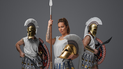 Antique greek warrior woman and military men dressed in tunics and plumed helmets.