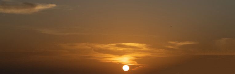 Sunset sunrise over Patong Beach Phuket Thailand clear blue and turquoise waters and lovely blue skies sun setting over the horizon of Andaman sea 