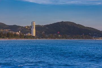 Fototapeta premium Patong Beach Phuket Thailand nice white sandy beach clear blue and turquoise waters and lovely blue skies with Palms tree sunset sunrise