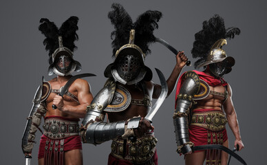 Fototapeta na wymiar Studio shot of antique roman warriors dressed in armors and plumed helmets.