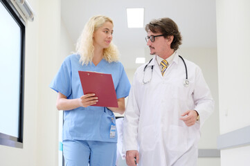 Male doctor and female doctor walking in the hospital.