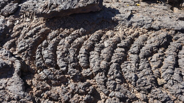 Corded lava close-up in Teide National Park, brown lava texture, geology 