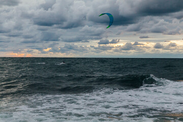 kitesurfing sport on the water sea sky in the clouds storm nature windsurfing