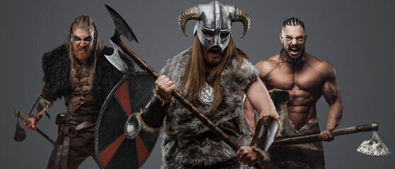 Shot of group of three barbaric vikings with armour and cold steel.