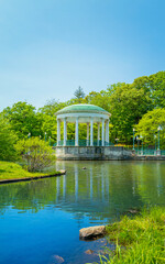 Pavilion, trees, rock, and water reflections on the pond at Roger Williams Park in Providence, Rhode Island