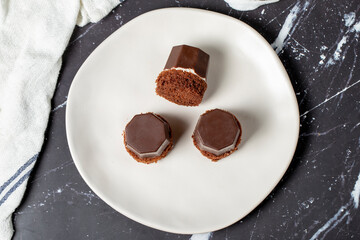 Cookies covered in milk chocolate. Liquid chocolate chip cookies on a dark background. Top view