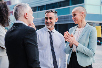 Group of business people talking together at workplace. Three coworkers having a friendly conversation of job. startup teamwork on a corporate employee meeting. Executive brainstorming and cooperating
