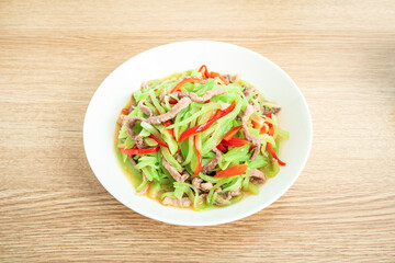 A home-cooked dish lettuce shredded fried meat on the table